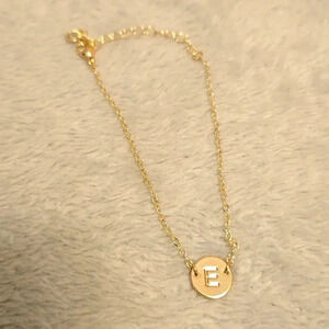 #340 Gold tone bracelet with letter E